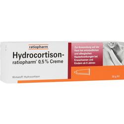 Weiße Verpackung von Hydrocortison-Creme mit orangem Bereich und Anwendungshinweisen.